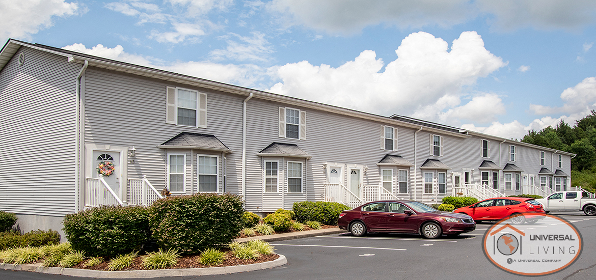 an apartment building with cars parked in front of it